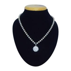 A well crafted brown-hued round pearl necklace set with an AD studded floral pendant