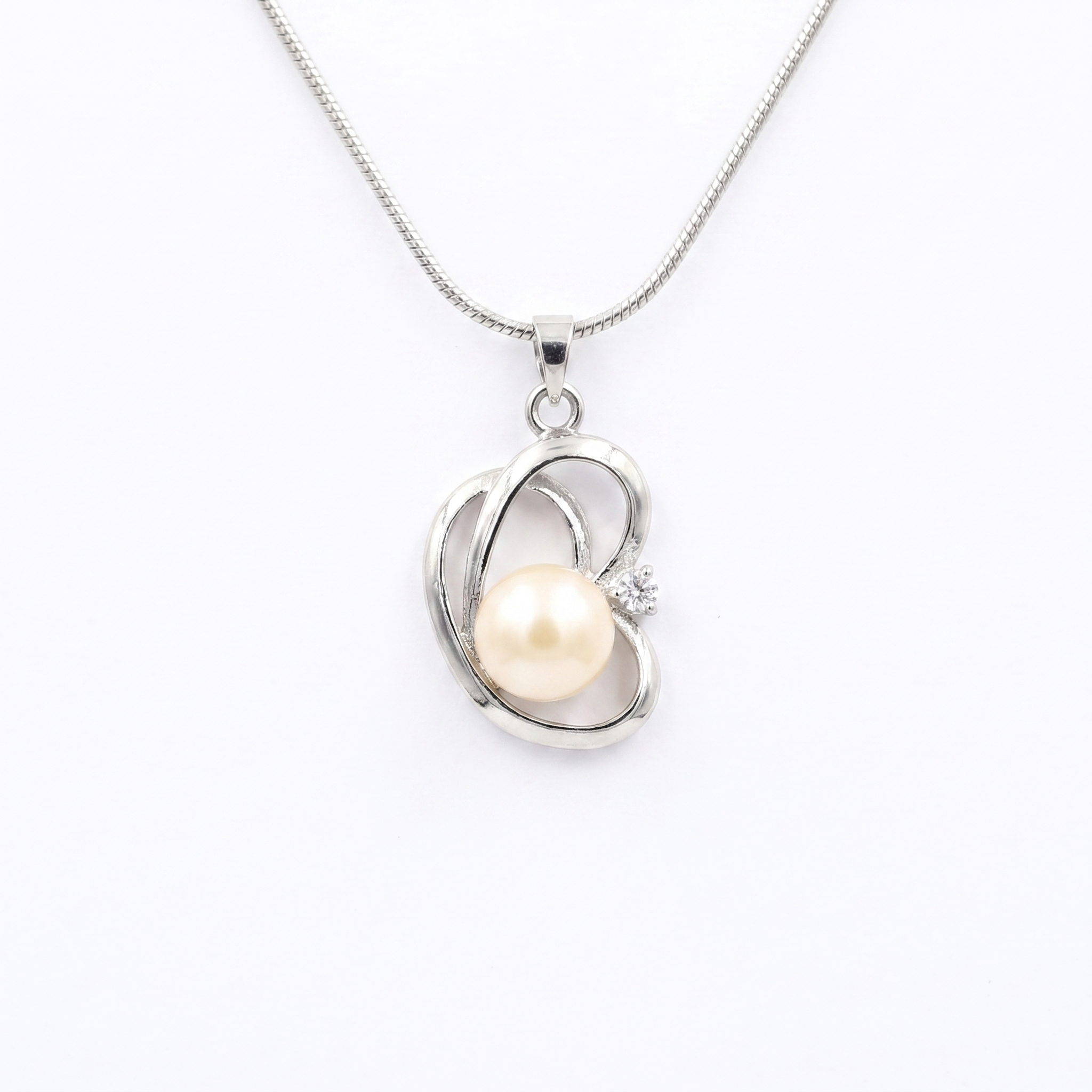 Elegant CZ Heart Pendant Accentuated With 10.5mm Peach Button Pearl