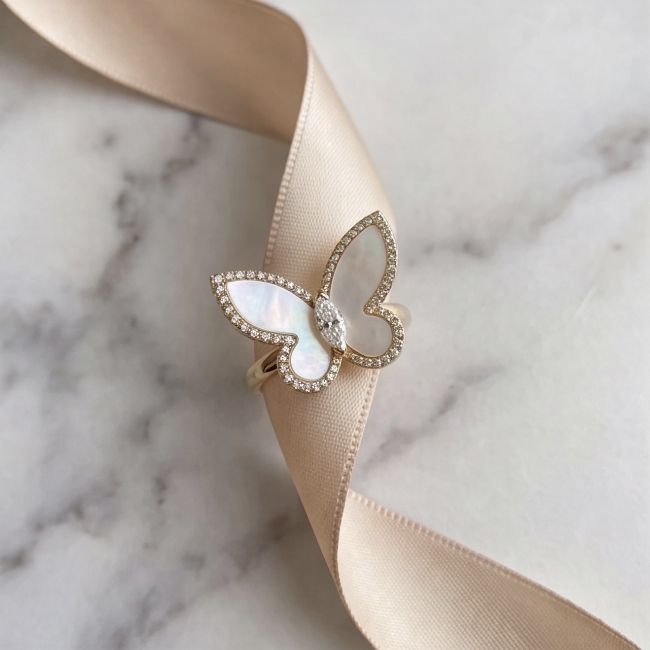 Gold-toned mother of pearl butterfly ring styled on a satin ribbon - Pure Pearls