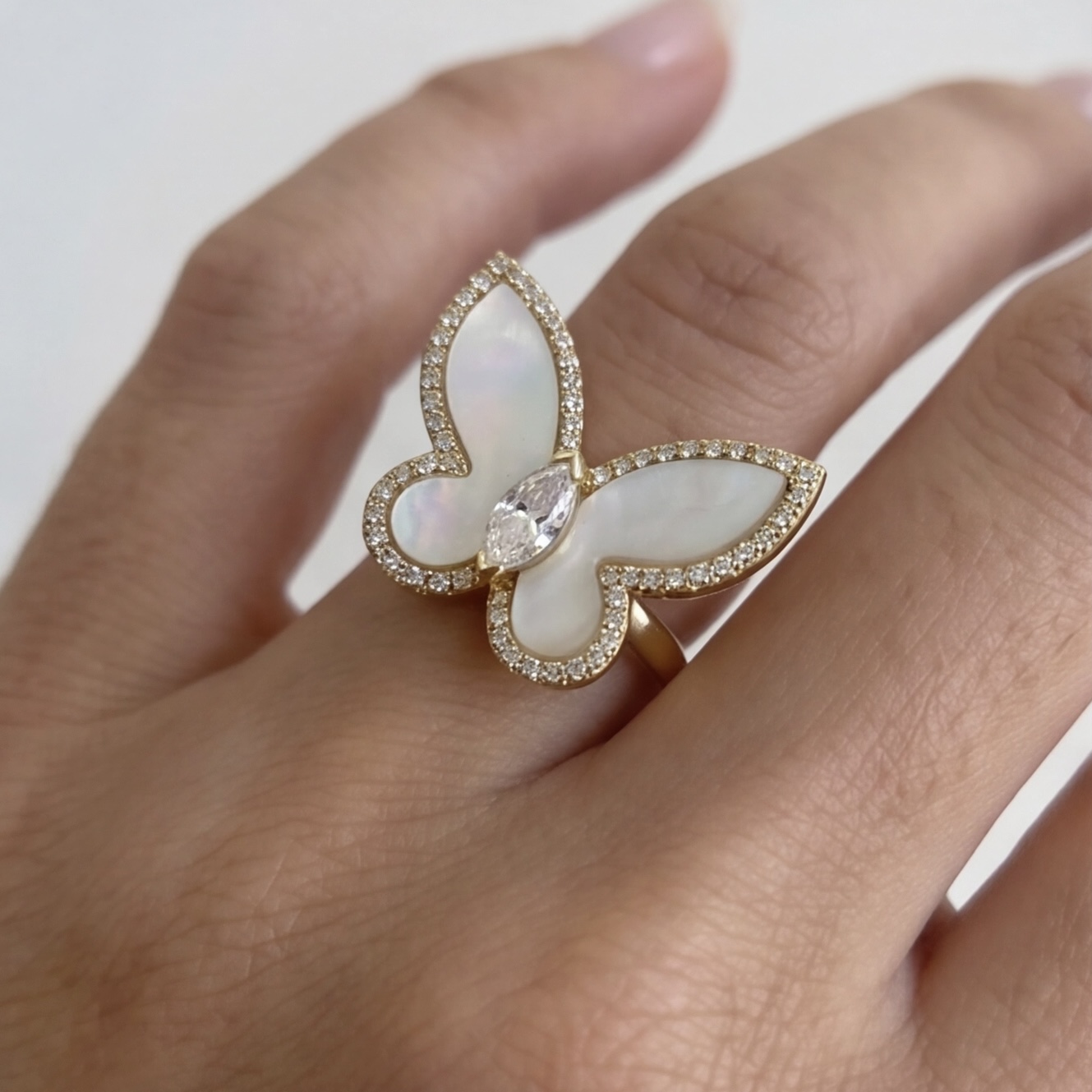 Mother of pearl butterfly ring worn on the finger, front view - Pure Pearls