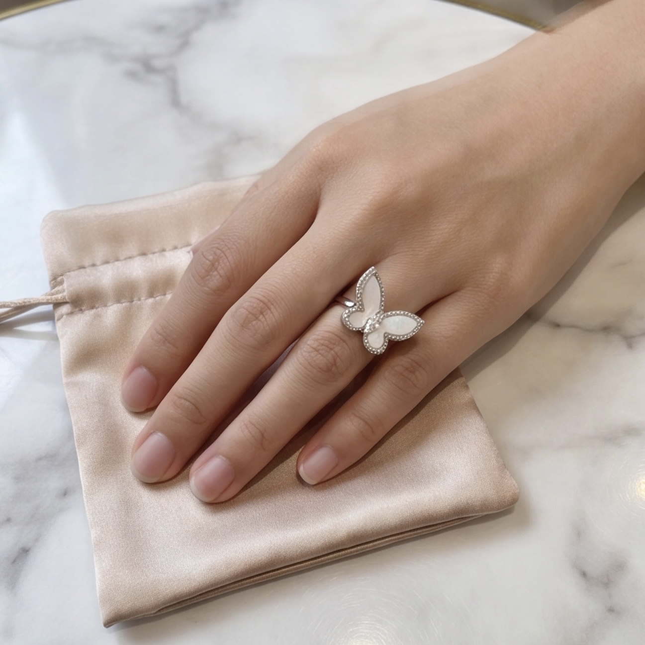 Silver mother of pearl butterfly ring worn on the finger - Pure Pearls