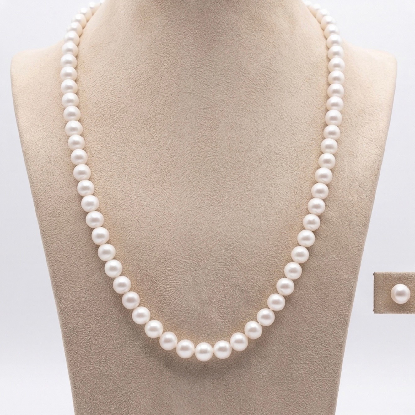 White round freshwater pearl matinee-length necklace displayed on a bust - Pure Pearls