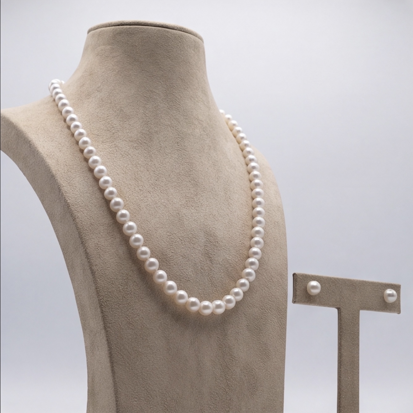 Angled view of white pearl matinee necklace and matching stud earrings set - Pure Pearls