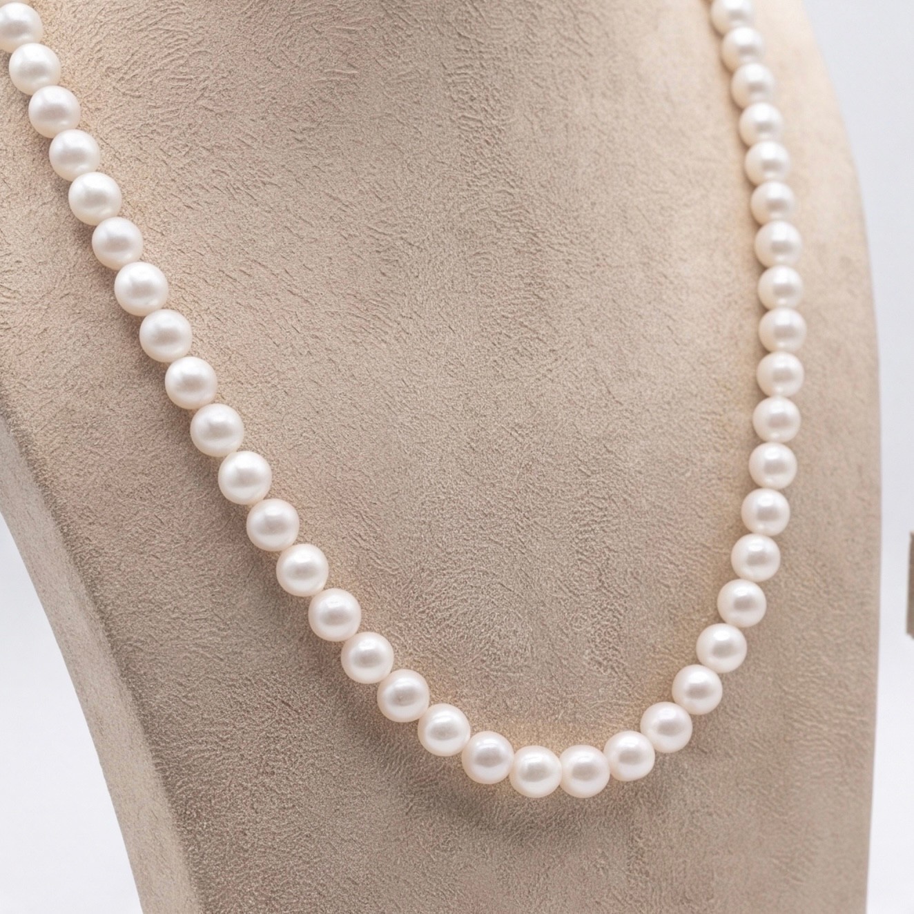 Detail of white round 7mm freshwater pearls in a matinee-length necklace - Pure Pearls