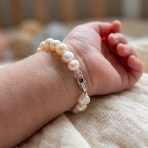 White baroque baby pearl bracelet with anti-allergic 925 silver clasp on a baby's wrist - Pure Pearls