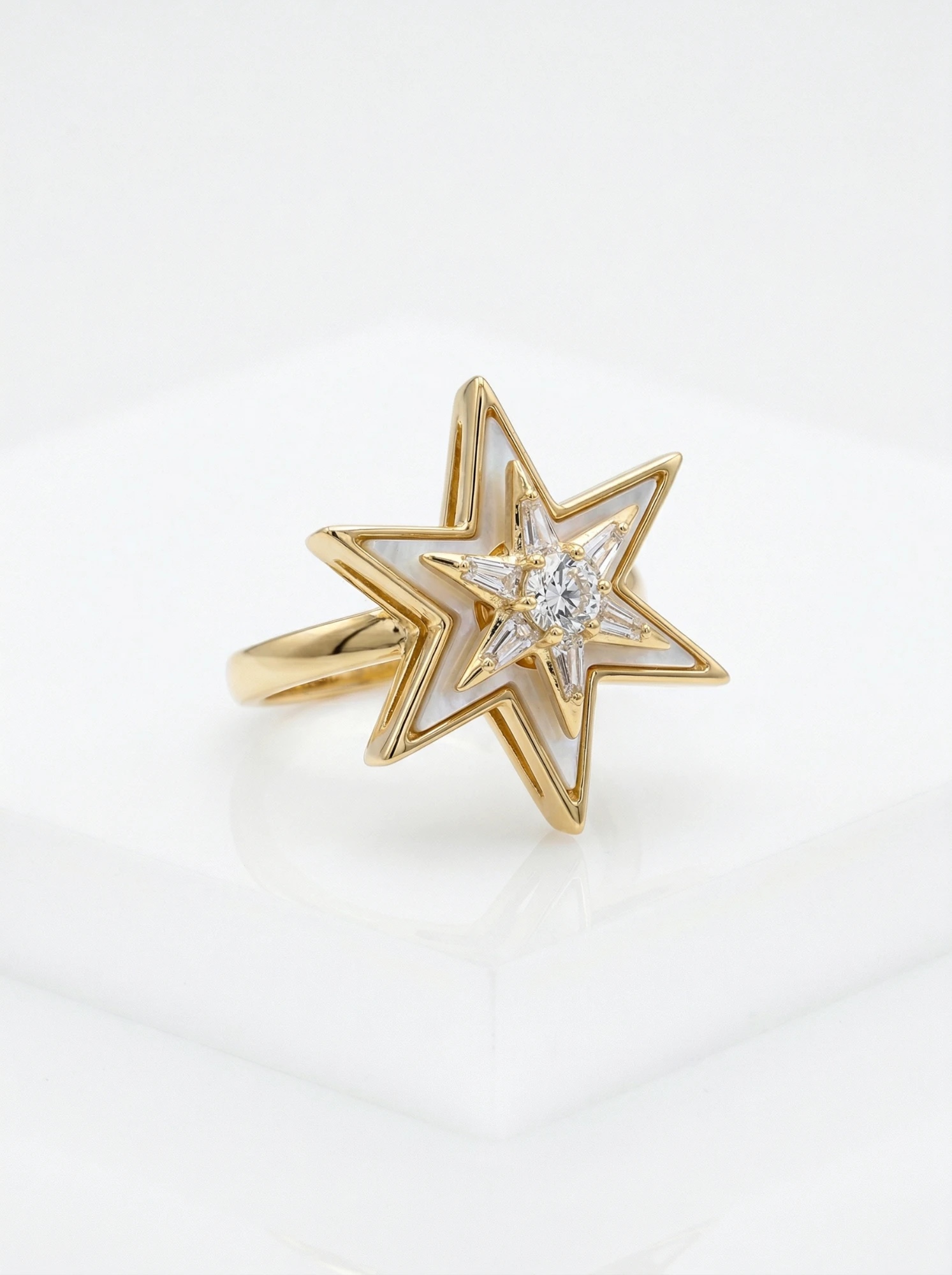 Mother of pearl star ring shown at an angle on a white block - Pure Pearls