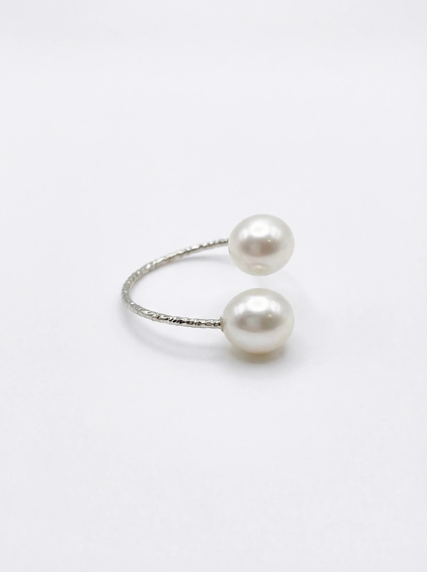 Angled view of the two pearl open ring showing the textured silver-toned band - Pure Pearls